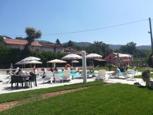 a group of people sitting in chairs by a pool at Agriturismo La Palazza in Sala Consilina