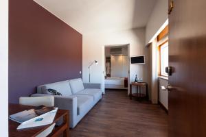 a living room with a couch and a table at Hotel Rali Viana in Viana do Castelo