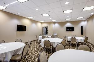 a conference room with white tables and chairs at Comfort Inn Bonner Springs Kansas City in Bonner Springs