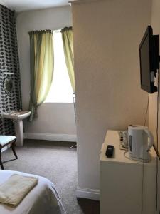 a hotel room with a bed and a window at Coach and Horses in Barnard Castle