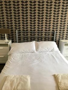 a bed with white sheets and pillows in a bedroom at Coach and Horses in Barnard Castle