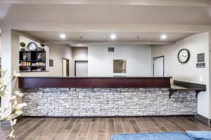 a bar in a lobby with a stone wall at Comfort Inn Bonner Springs Kansas City in Bonner Springs