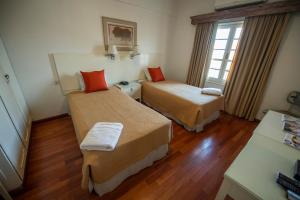 Hotel Cecilia tesisinde bir odada yatak veya yataklar