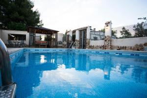 a large swimming pool with blue water at Casa el Olivar de Don Pedro in Cobisa