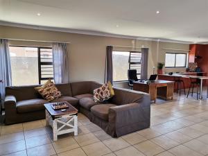 a living room with a couch and a table at Bread & Barrel Eureka Kimberley in Kimberley