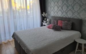 a bedroom with a bed with pillows on it at Polana in Nowy Targ
