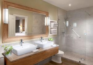 a bathroom with two sinks and a shower at The Galmont Hotel & Spa in Galway