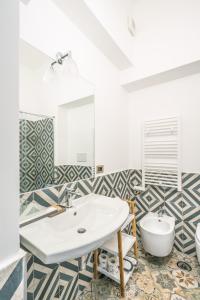 a bathroom with a white sink and a toilet at Don Giulio Luxury Home jacuzzi in Vico Equense