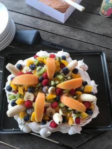 a plate of fruit and vegetables on a table at Maison d'Hôtes Lassaubatju in Hontanx