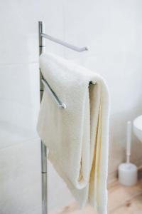 a towel rack with white towels hanging on it at Dorisol Vista Formosa by rentallido in Funchal
