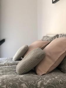 a woman laying on a bed with two pillows at Apartman Spring in Sombor
