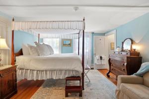 
a bedroom with a bed and a dresser at Martin House Inn in Nantucket
