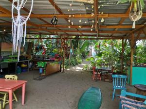 a patio with tables and chairs and plants at Oasis in Puerto Viejo