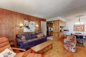 a living room with a couch and a table at Fireside at the Village in Mammoth Lakes