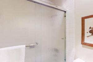 a shower with a glass door in a bathroom at Fireside at the Village in Mammoth Lakes