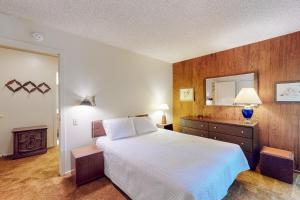 a bedroom with a large bed and a mirror at Fireside at the Village in Mammoth Lakes