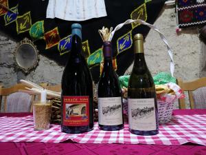 three bottles of wine sitting on a table at "Pivnica i smestaj Jovanovic"- Rogljevacke pivnice in Rogljevo