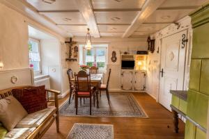 a living room with a table and chairs and a kitchen at Ferienhaus St. Michael in Öhningen