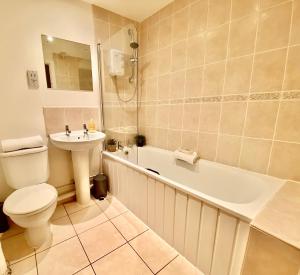 a bathroom with a toilet and a sink and a tub at Liverpool city centre apartment on Duke Street in Liverpool