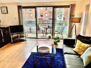 a living room with a couch and a table at Liverpool city centre apartment on Duke Street in Liverpool