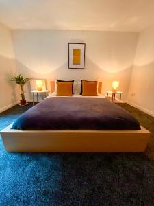 a bedroom with a large bed with two side tables at Liverpool city centre apartment on Duke Street in Liverpool