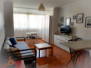 a living room with a couch and a table at Apartment Chaparral Complex in Costa Del Silencio