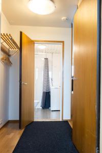 a hallway with a door leading to a bathroom at Tuure´s studio near to Art Museum in Turku