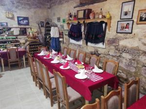 a table in a restaurant with a red table cloth at "Pivnica i smestaj Jovanovic"- Rogljevacke pivnice in Rogljevo