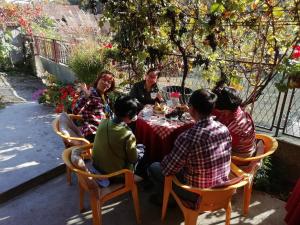 a group of people sitting around a table at "Pivnica i smestaj Jovanovic"- Rogljevacke pivnice in Rogljevo