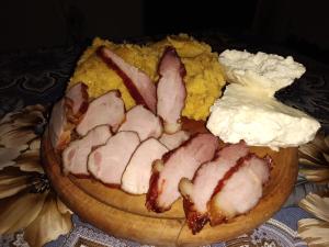a plate of food with meat on top of cornbread at "Pivnica i smestaj Jovanovic"- Rogljevacke pivnice in Rogljevo
