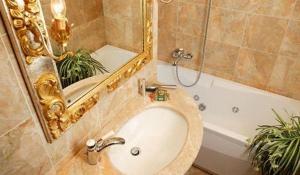 a bathroom with a sink and a tub with a mirror at Best Windows in Venice