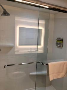 a glass shower with a window in a bathroom at Holiday Inn Express Hotel & Suites Clewiston, an IHG Hotel in Clewiston