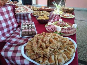 a table topped with plates of food on a red and white table cloth at "Pivnica i smestaj Jovanovic"- Rogljevacke pivnice in Rogljevo