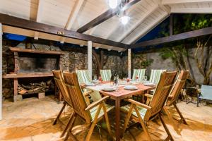 a dining room with a table and chairs and a fireplace at Holiday Home Rosko in Skradin