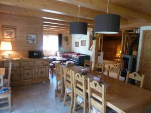 a kitchen and living room with a table and chairs at Chalet Le Solaret in Megève