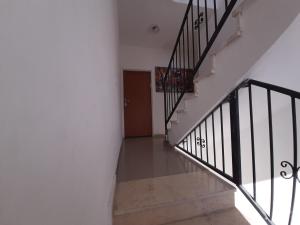 a hallway with stairs and a wooden door at Family apart in Nahariyya