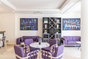 a living room with purple chairs and a table at Art Hotel Dubrovnik in Dubrovnik