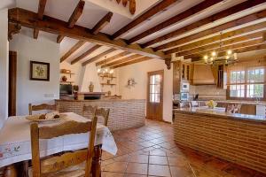 a kitchen with a table and a counter in a room at Casa Rural Tita Ines in El Chorro