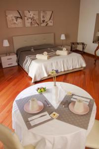 a hotel room with a bed with a table with hats on it at La Cattedrale in Ruvo di Puglia