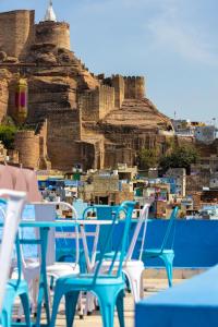 a group of blue and white chairs in front of a castle at Jewel Palace Haweli in Jodhpur