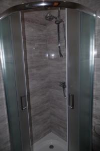 a shower with a glass door in a bathroom at Tawerna Akropolis in Ostrów Mazowiecka +37 photos