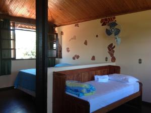 Ένα ή περισσότερα κρεβάτια σε δωμάτιο στο Pousada Por do Sol