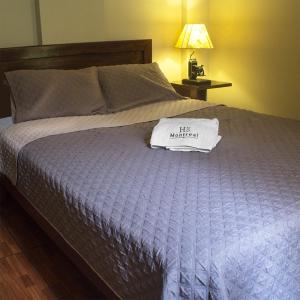 Ένα ή περισσότερα κρεβάτια σε δωμάτιο στο Montreal Hostal