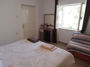 Postel nebo postele na pokoji v ubytování Apartments Sandra