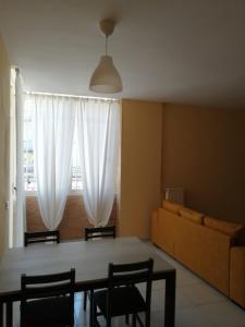a living room with a table and a couch at La casa del ciliegio - appartamento a Caserta in Caserta