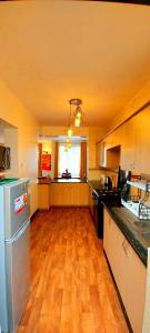 A kitchen or kitchenette at Little Green Room Homestay near JKIA Airport & SGR Railway Station