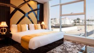 a bedroom with a large bed with a large window at Golden Dream Hotel in Khamis Mushayt +46 photos
