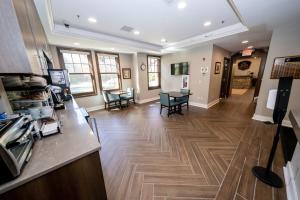 a large room with a kitchen and a living room at The Inn at Shattuck - St. Mary's in Faribault