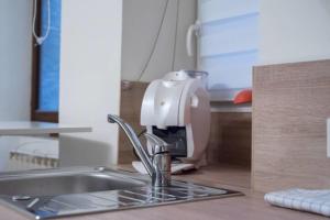 a mixer sitting on a kitchen counter next to a sink at Le Veyrier - Small studio for 2 people in the heart of the old town in Annecy