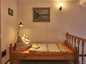 a bed with pillows on it in a room at Hardy Apartman in Keszthely